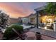 Beautiful backyard with a sparkling pool, shaded seating area, and lush landscaping at 5113 W Molly Ln, Phoenix, AZ 85083