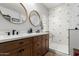 Modern bathroom featuring a double vanity, decorative mirrors, and a stylish geometric-tiled shower at 5113 W Molly Ln, Phoenix, AZ 85083