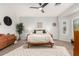 A spacious bedroom with a modern ceiling fan, decorative rug, and neutral decor for a serene atmosphere at 5113 W Molly Ln, Phoenix, AZ 85083
