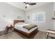 Comfortable bedroom featuring a bed, side table, and a window with shutter blinds at 5113 W Molly Ln, Phoenix, AZ 85083