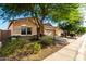 Charming home featuring a two-car garage, neutral stucco, stone accents, and a meticulously manicured landscape at 5113 W Molly Ln, Phoenix, AZ 85083