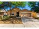 Charming home featuring a two-car garage, neutral stucco, stone accents, and a meticulously manicured landscape at 5113 W Molly Ln, Phoenix, AZ 85083