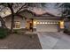 Charming home featuring a two-car garage, neutral stucco, stone accents, and a meticulously manicured landscape at 5113 W Molly Ln, Phoenix, AZ 85083