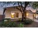 Charming home featuring a two-car garage, neutral stucco, stone accents, and a meticulously manicured landscape at 5113 W Molly Ln, Phoenix, AZ 85083