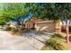 Charming home featuring a two-car garage, neutral stucco, stone accents, and a meticulously manicured landscape at 5113 W Molly Ln, Phoenix, AZ 85083