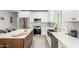 Bright kitchen with stainless appliances, white cabinets, backsplash and island with bar stools at 5113 W Molly Ln, Phoenix, AZ 85083