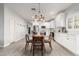 Open-concept kitchen and dining area with stainless steel appliances and white cabinets at 5113 W Molly Ln, Phoenix, AZ 85083