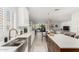 Open concept kitchen with white cabinets, stainless steel appliances, and view into living room at 5113 W Molly Ln, Phoenix, AZ 85083