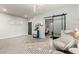 Inviting space featuring trendy decor, including a sliding barn door, light gray walls, and wood-look tile floors at 5113 W Molly Ln, Phoenix, AZ 85083