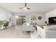 Bright living room with sliding glass doors to backyard, fan, and comfortable seating at 5113 W Molly Ln, Phoenix, AZ 85083