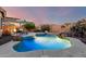 Beautiful pool and patio area at dusk with lush landscaping, creating a serene and private outdoor oasis at 5113 W Molly Ln, Phoenix, AZ 85083