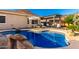 Sparkling private pool with rock accents, lush landscaping, a covered patio, and comfortable lounge chairs at 5113 W Molly Ln, Phoenix, AZ 85083