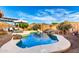 Inviting pool area with mature trees, lush plantings, a rock waterfall, and a nearby pergola at 5113 W Molly Ln, Phoenix, AZ 85083
