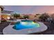 Inviting pool with rock waterfall feature, lush landscaping, and comfortable lounge area at 5113 W Molly Ln, Phoenix, AZ 85083