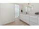 Modern bathroom with white cabinets, a quartz countertop, updated fixtures and a walk-in shower at 5420 W Grove St, Laveen, AZ 85339