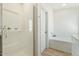 Clean bathroom featuring a glass-enclosed shower, a soaking tub and modern fixtures at 5420 W Grove St, Laveen, AZ 85339