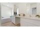 Bright bathroom featuring dual sinks, large mirrors, and a separate soaking tub for relaxation at 5420 W Grove St, Laveen, AZ 85339