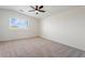 Bright bedroom with a window offering lots of natural light and a ceiling fan for added comfort at 5420 W Grove St, Laveen, AZ 85339