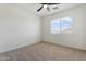 Bright bedroom with carpeted floor, a ceiling fan, and a window offering lots of natural light at 5420 W Grove St, Laveen, AZ 85339