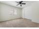 Cozy bedroom featuring a ceiling fan, a window, neutral carpet and a closet with sliding doors at 5420 W Grove St, Laveen, AZ 85339