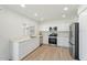 Clean and modern kitchen with white cabinets, stainless steel appliances, and ample counter space at 5420 W Grove St, Laveen, AZ 85339