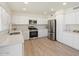Bright kitchen with white cabinets, stainless steel appliances, and updated fixtures, ready for cooking at 5420 W Grove St, Laveen, AZ 85339