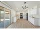 Modern kitchen with white cabinets, stainless steel appliances, and a sliding door to outdoor space at 5420 W Grove St, Laveen, AZ 85339