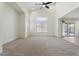 Open-concept living room with vaulted ceilings, large windows, and sliding glass doors to the backyard at 5420 W Grove St, Laveen, AZ 85339