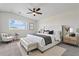 Stylishly staged main bedroom with a neutral color palette and well-placed décor and furniture at 5420 W Grove St, Laveen, AZ 85339
