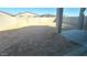 The backyard has a wall and a dirt lot with a small concrete patio at 5657 S 253Rd Ave, Buckeye, AZ 85326