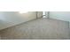 An empty bedroom with carpet and white walls provides a blank canvas at 5657 S 253Rd Ave, Buckeye, AZ 85326
