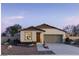 Charming single-story home showcasing desert landscaping and a two-car garage in a peaceful community at 5657 S 253Rd Ave, Buckeye, AZ 85326