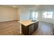 A kitchen island with a sink is shown in this modern kitchen layout at 5657 S 253Rd Ave, Buckeye, AZ 85326