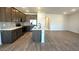 Modern kitchen with wood cabinets, stainless appliances, and kitchen island with sink at 5657 S 253Rd Ave, Buckeye, AZ 85326
