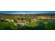 An aerial view showcases a golf course, clubhouse, pool, and tennis courts at 6502 W Wahalla Ln, Glendale, AZ 85308