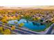 Scenic aerial view of a Primary-planned community with a serene lake and fountain at 6502 W Wahalla Ln, Glendale, AZ 85308