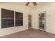 Covered back patio featuring neutral walls, tile flooring, a window, and two metal screen doors at 6502 W Wahalla Ln, Glendale, AZ 85308