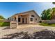 An exterior view shows the backyard with artificial turf and an outdoor kitchen at 6502 W Wahalla Ln, Glendale, AZ 85308