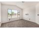 Bright bedroom featuring carpet, a vaulted ceiling, and natural light from a large window at 6502 W Wahalla Ln, Glendale, AZ 85308