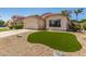 Charming home featuring desert landscaping, a two-car garage, and a well-maintained lawn at 6502 W Wahalla Ln, Glendale, AZ 85308