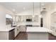 Modern kitchen with white cabinets, stainless steel appliances, and pendant lighting over the island at 6502 W Wahalla Ln, Glendale, AZ 85308