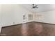 Open-concept living room with sleek dark wood flooring and a ceiling fan at 6502 W Wahalla Ln, Glendale, AZ 85308