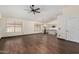 Open-concept living room with sleek dark wood flooring that leads into the kitchen at 6502 W Wahalla Ln, Glendale, AZ 85308