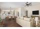 Bright, open concept living area with hardwood floors seamlessly connects to the kitchen at 6502 W Wahalla Ln, Glendale, AZ 85308