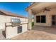 A covered patio features stone floors and a built-in barbecue area at 6502 W Wahalla Ln, Glendale, AZ 85308