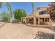 Backyard featuring desert landscaping, mature trees and a covered patio, creating a serene outdoor space at 728 W Sandra Ter, Phoenix, AZ 85023