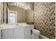 Elegant powder room with decorative wallpaper and a pedestal sink at 728 W Sandra Ter, Phoenix, AZ 85023
