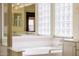 Bright bathroom featuring a bathtub with glass block windows for natural light at 728 W Sandra Ter, Phoenix, AZ 85023