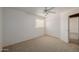 Bedroom featuring a ceiling fan, carpeted floor and a double door closet at 728 W Sandra Ter, Phoenix, AZ 85023