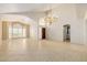 Bright living room with tile floors, arched windows, and a chandelier at 728 W Sandra Ter, Phoenix, AZ 85023